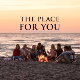 a group of people sitting on a beach