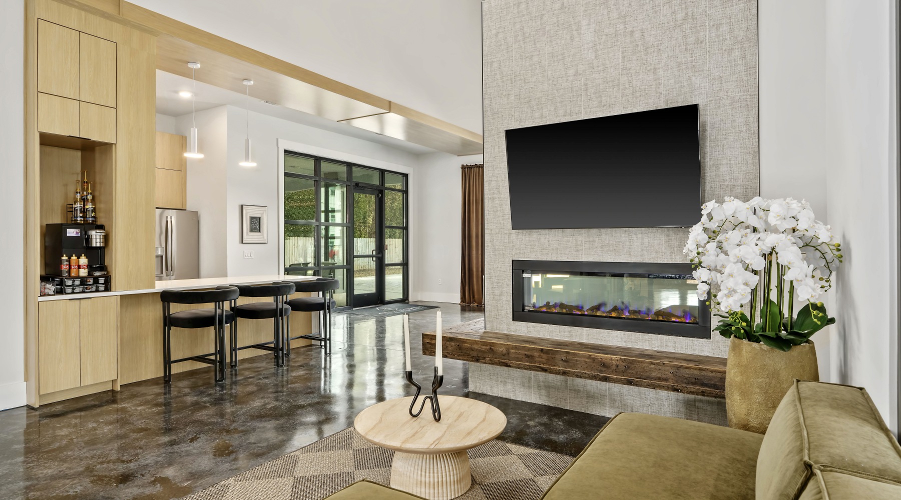 Clubhouse seating area with tv and fireplace at City North in Pensacola, FL