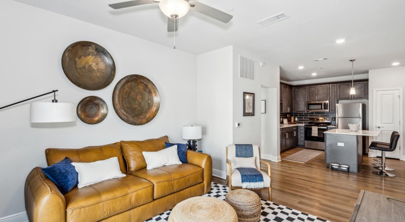 a living room with a couch and a fan